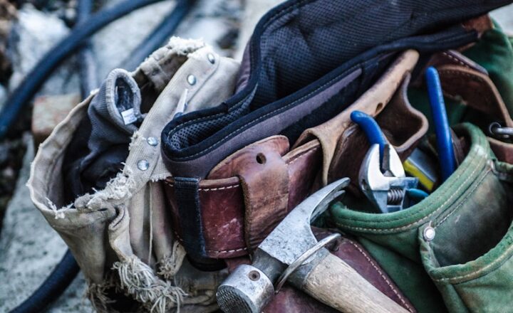 brown handled hammer and with tool belt